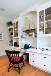 comfortable home office with white built in cabinets